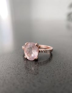 Crafted in 14K rose gold over silver, this breathtaking ring features an oval-shaped natural rose quartz stone. The shank glistens with petite cubic zirconia to complete the design.
Being a stone of unconditional love, Rose Quartz will purify and open your heart at all levels to promote harmony, deep inner healing and feelings of peace. Classic Rose Gold Jewelry With Accent Stones, Formal Rose Gold Sterling Silver Stackable Rings, Elegant Pink Topaz Ring In Sterling Silver, Elegant Adjustable Sapphire Ring, Elegant Rose Gold Sapphire Ring In Sterling Silver, Elegant Rose Gold Sterling Silver Birthstone Ring, Elegant Rose Gold Sterling Silver Crystal Ring, Classic Rose Gold Sterling Silver Rings, Classic Rose Gold Rings With Accent Stones