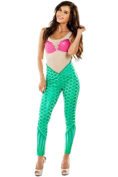 a woman in green and pink swimsuit with fish scales on her leggings