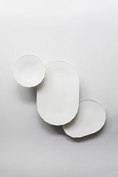 three white plates sitting on top of each other