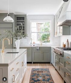 a kitchen with green cabinets, white counter tops and an area rug on the floor