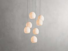 a group of white lights hanging from a ceiling