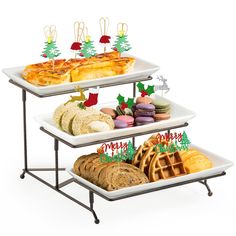 three tiered trays with christmas food on them and holiday decorations in the background