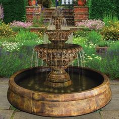 a water fountain in the middle of a garden