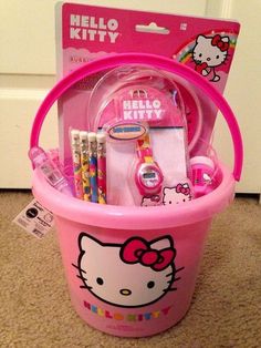 a pink hello kitty bucket with pens, pencils and markers