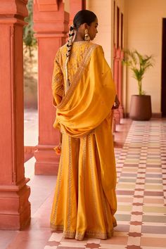 Mustard kurta with marodi embroidery. Comes with sharara and a dupatta.
Components: 3
Pattern: Embroidered
Type Of Work: Marodi
Neckline: Round
Sleeve Type: Three quarter
Fabric: Silk, Organza silk
Color: Yellow
Other Details: 
Note: Outfit worn by the model on the right is not for sale.
Occasion: Sangeet - Aza Fashions Traditional Chanderi Sharara, Traditional Sharara With Dupatta And Traditional Drape, Traditional Chanderi Sharara With Cutdana, Banarasi Silk Palazzo Set With Dabka Work, Traditional Dola Silk Sharara For Transitional Season, Traditional Sharara With Dupatta, Traditional Palazzo Set For Navratri With Traditional Drape, Traditional Slub Silk Sharara With Dori Work, Art Silk Palazzo Set With Traditional Drape And Pallu