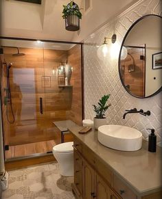 a bathroom with a sink, toilet and shower stall in it's own area