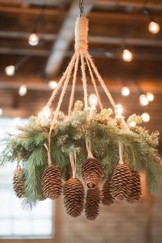 a chandelier with pine cones and evergreen needles hanging from it's center