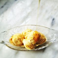 ice cream being poured into a glass bowl