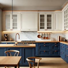 a kitchen with blue cabinets and wooden tables in the center, along with white cupboards