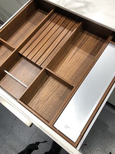 an open drawer on top of a white table