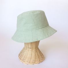 The perfect linen bucket hat! Made from a mint green linen blend fabric. This hat is very comfortable to wear. A great sun hat for women or men. I made this hat with a day of adventure in mind, somewhere sunny and wild! For baby or kid version of this hat, see link below. This hat is made from a mint green linen and cotton blend fabric. Inside liner is white cotton. Interfacing inside brim for extra shape. Brim measures approx. 2.5" wide. Crown measures approx. 3.5" deep. **Hat on models in diff