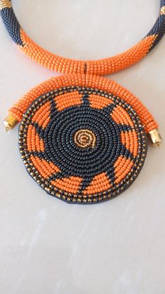 African Necklace, African Jewelry, African Beaded Necklace, Zulu Beaded Necklace, Orange Necklace, Pendant Necklace, Gift For Her This stunning pendant necklace is superbly crafted which makes you stands out in any occasion. Main Color - Orange. Different colors of your choice can be available. Wholesale available at a fair price. For any query please send me a convo or an e-mail. Happy Shopping Orange Beaded Round Necklace, Orange Necklace With Black Beads For Gift, Gift Necklace With Orange And Black Beads, Artisan Black Beaded Necklaces For Jewelry Making, Orange Necklace With Black Round Beads, Traditional Beaded Necklaces With Spacer Beads For Crafting, Colorful Beaded Necklaces For Jewelry Making, Orange Beaded Necklaces With Spacer Beads As Gift, Orange Beaded Necklace As A Gift