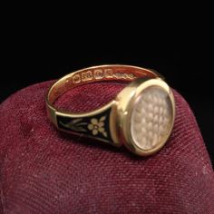 Beautiful Antique Victorian 18K Yellow Gold Enamel Hair Mourning Ring. This amazing ring has pristine enameling and the hair is still intact inside the glass. It has flower designs on the side of the ring without any damage which is rare. The inside of the ring is hallmarked.Item #R0926Metal: 18K Yellow Gold.Weight: 4 GramsRing Size: 8Measurements: Top measures 13 mm wide and band measures 2.8 mm wide.Measurement from finger to top of ring: 3.75  mmLayaway: For your convenience, we will be happy Vintage Gold Enamel Ring Stamped 14k, Victorian Enamel Ring Engraved For Anniversary, Victorian Style Hallmarked Enamel Ring For Anniversary, Victorian Engraved Enamel Ring For Anniversary, Heirloom Oval Engraved Enamel Ring, Heirloom Engraved Oval Enamel Ring, Victorian Gold Enamel Ceremonial Ring, Victorian Yellow Gold Enamel Ring, Victorian Yellow Gold Enamel Ring For Anniversary