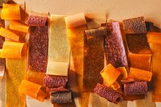 several different types of food are arranged on a cutting board, including carrots and cheese