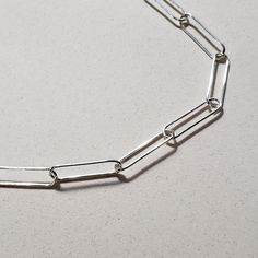 This is an image of a 20 sterling silver paperclip chain necklace by Jennifer Favour. This chain is long and lightweight and has a lobster clasp closure. Cable Chain Necklace, Fitness Bracelet, Ring Fit, Silver Chain Necklace, Paper Clip, Minimalist Style, Cable Chain, Ring Bracelet, Jewelry Care