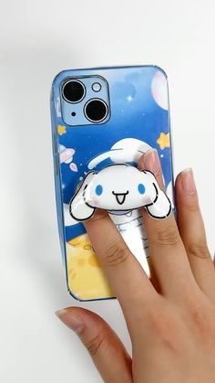 a person holding up a phone case with a cartoon character on it