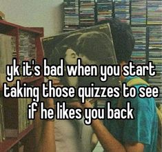 someone holding up a book in front of a shelf with cds on it and the caption says, yk it's bad when you start taking those quizzes to see if he likes you back