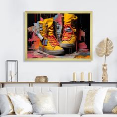 a living room with a white couch and yellow shoes on the floor in front of it