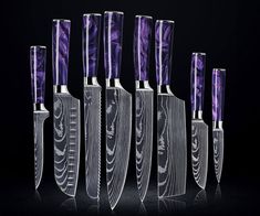 six knives are lined up next to each other on a black background with purple swirls