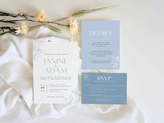 the wedding stationery is laid out next to some flowers