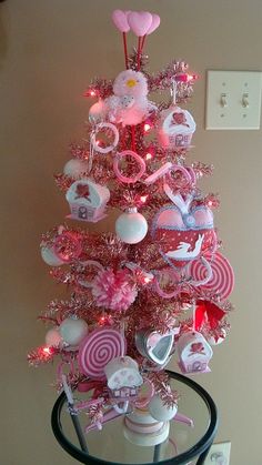 a pink christmas tree with lots of decorations