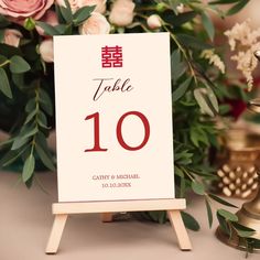 a table number sign sitting on top of a wooden easer