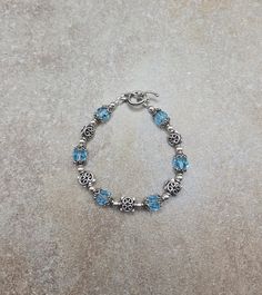 one of a kind sterling bracelet, vintage beaded bracelet, blue Swarovski jewelry Sterling Silver and Swarovski Crystal Handmade Bracelet 7 " all 4mm round beads are sterling silver. All square spacer beads, bead caps and toggle clasp are Bali sterling silver. Swarovski crystals are 8mm round aquamarine Check out my other jewelry at https://loveofjewelryshop.etsy.com *All of my Swarovski crystal bracelets, earrings, and necklaces are my own design using beads I purchased over 20 years ago. Nickel-free Blue Sterling Silver Bracelet As A Gift, Adjustable Blue Sterling Silver Nickel-free Bracelet, Sterling Silver Crystal Bracelet With Silver Beads As Gift, Blue Beaded Crystal Bracelet In Sterling Silver, Blue Beaded Sterling Silver Crystal Bracelet, Adjustable Blue Crystal Bracelet For Anniversary, Blue Nickel-free Crystal Bracelet For Gift, Elegant Blue Nickel Free Charm Bracelet, Blue Faceted Beads Bracelet