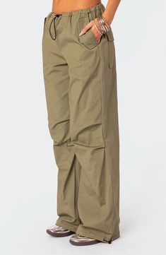 A baggy, Y2K-inspired fit gives you room to move in these lightweight, stretch-kissed cotton pants featuring utilitarian drawcords and cargo pockets. Drawcord-toggle waist Front slant flap pockets; back flap patch pockets; cargo flap-patch pockets Drawcord-toggle cuffs 95% cotton, 5% spandex Machine wash, dry flat Imported Cargo Parachute Pants, Parachute Trousers, Slim Fit Cargo Pants, Curve Jeans, Fashion Comfortable, Baggy Y2k, Baggy Pant, Oversized Silhouette, Slim Fit Pants