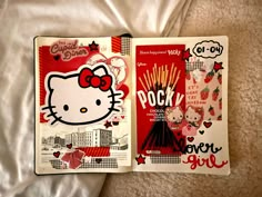 two hello kitty books laying on top of a bed