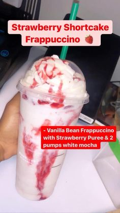 strawberry shortcake frapuccino in a plastic cup with strawberries and whipped cream