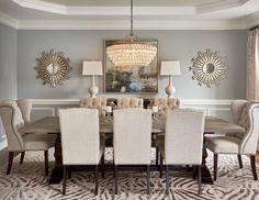 a dinning room table with chairs and a chandelier