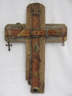 a wooden cross hanging on the side of a wall