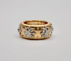 Lower prices on our main website: www.shopdiscomarshmallow.com Indulge in the luxurious allure of our 18k Engraved Gold Silk-Inspired Ring, a masterpiece of craftsmanship and elegance. With a generous width of 10mm, this ring captivates with intricate engravings that artfully mimic the soft folds of silk fabric, adding a touch of timeless sophistication to your ensemble. Adorned with a delicate diamond flower inlay, each petal sparkles with brilliance, creating a harmonious blend of opulence and nature-inspired beauty. White gold studs accentuate the design, contributing a contemporary edge to this exquisite piece.  Item Details * Made to Order. * Gold Kt: 18K Solid Yellow Gold * Diamond Cut: Round * Diamond Clarity: VS * Diamond Color: F - G * Ready to Ship in 15-20 business days If you h Ring Finger Rings, White Gold Studs, Right Hand Ring, Gold Engraving, Hand Ring, Unique Wedding Bands, Vs Diamond, Gold Silk, Brooch Jewelry