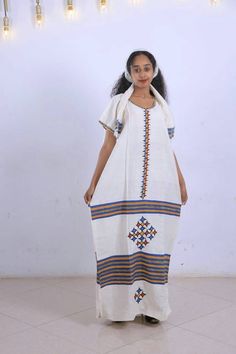 ● Beautifully and carefully made. ● 51 Inchs Long. ● 28 Inches Width. ● very Beautiful and comfortable. ● 100% Made from Cotton. ● It Comes with the Scarf/Headband (Netela) and rope belt (Mekenet) as Shown on the picture. ● Hand Wash Festive White Dress With Weaving Work, White Habesha Kemis For Traditional Ceremonies, White Dresses With Weaving Work For Traditional Ceremonies, Traditional White Habesha Kemis For Wedding, Ceremonial Habesha Kemis For Eid With Traditional Patterns, Traditional Off White Dress For Festivals, Festive Folk Habesha Kemis With Traditional Patterns, Traditional Off-white Dress For Festivals, Festive Ceremonial Habesha Kemis With Woven Motifs