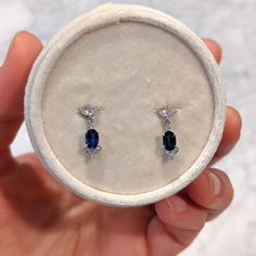 Our bridal drop earrings set with blue sapphires and diamonds are perfect for brides who want to add glamour and color to their bridal look in a subtle and elegant way. Available in 14k and 18k yellow rose and white gold, as well as platinum--just choose your desired metal from the drop-down menu! These earrings are fully customizable. Prefer different dimensions? Would you like to add ruby or emeralds or other colored gemstones in place of blue sapphires and diamonds? Contact us today for a no- Blue Sapphire Oval Diamond Earrings, Elegant Blue Oval Diamond Earrings, Fine Jewelry Sapphire Oval Earrings, Oval Sapphire Earrings Fine Jewelry, Sapphire Diamond Drop Earrings In Fine Jewelry Style, Sapphire Diamond Drop Earrings, Oval Sapphire Earrings With Diamond Accents, Elegant Tanzanite Dangle Earrings, Sapphire Oval Diamond Earrings