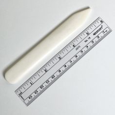 a white plastic ruler sitting on top of a table