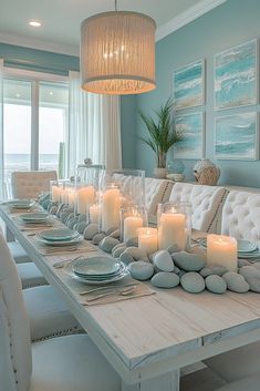 a dining room table with candles and plates on it