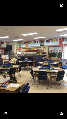 an empty classroom with desks, chairs and other items on the tables in front of them