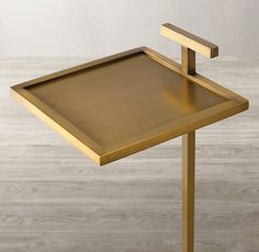 a gold desk with a metal tray on it