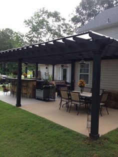 a covered patio with table and chairs