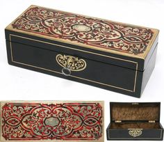 an ornately decorated box with gold trimmings and red, black, and white designs