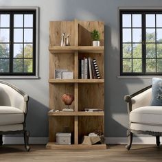 a living room with two chairs and a book shelf