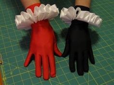 there are two gloves that have ruffles on the wrist and one is red