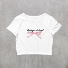 "Introducing our elegant \"Marriage Material\" white crop top, adorned with a charming pink bow - the ideal garment for any bride-to-be. This stylish and playful top is the perfect gift for engagements, bridal showers, or bachelorette parties, adding a touch of joy to the pre-wedding celebrations. Embrace the spirit of the occasion with this delightful crop top, designed to make any bride extra special. Celebrate love in style with this chic and unique addition to the bride's wardrobe.  Product details: 🎀 * 52% combed ring-spun cotton, 48% polyester * Fabric weight: 3.6 oz/yd² (122 g/m²) * XS/SM, M/L * Slim fit * Side-seamed construction * Blank product sourced from Nicaragua, the US, or Honduras This product is made especially for you as soon as you place an order, which is why it takes Fitted Bow Crop Top, Feminine White Crop Top For Wedding, White Feminine Crop Top For Wedding, Fitted Cropped Top With Bow, Fitted White Crop Top With Bow, White Bow Crop Top For Summer, Feminine Cotton Crop Top For Parties, White Cotton Top With Pink Bow, Cute White Top With Pink Bow