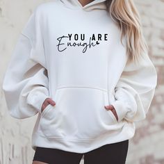 This 'You are enough' Hoodie exudes a positive and empowering vibe, making it a perfect addition to your casual wardrobe. Ideal for individuals seeking comfort and confidence in their daily attire, this unisex College Hoodie is relevant for self-care days, mental health awareness events, and cozy nights in. Product features - Side seams for structural support - Hood with adjustable drawstring - Spacious kangaroo pocket for warmth - 80% Ringspun Cotton, 20% Polyester composition - Medium heavy fa Sporty Slogan Hoodie In Relaxed Fit, Sporty Relaxed Fit Slogan Hoodie, Sporty Relaxed Fit Hoodie With Slogan, Everyday Hooded Hoodie With Letter Print, White Letter Print Hoodie For Workout, White Letter Print Workout Hoodie, Sporty Hoodie With Letter Print And Comfortable Fit, Inspirational Letter Print Relaxed Fit Hoodie, White Workout Hoodie With Letter Print