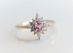 Skylar - Pink Sapphire solid 14k gold with 0.2 ct Diamond, White Sapphire or CZ, Pink Sapphire Halo Cluster Ring, Sapphire Engagement Ring by EmiConnerJewelry on Etsy https://www.etsy.com/listing/607513019/skylar-pink-sapphire-solid-14k-gold-with Pink Gemstone Cluster Ring, Pink Cluster Ring With Halo Setting, Wedding Pink Sapphire Ring With Halo Design, Pink Round Cluster Ring In Fine Jewelry Style, Pink Gemstone Cluster Ring In Fine Jewelry Style, Fine Jewelry Pink Cluster Ring, Pink Round Cut Cluster Ring Fine Jewelry, Pink Sapphire Cluster Ring Gift, Pink Sapphire Cluster Ring For Gifts