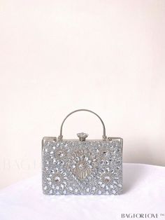 BagForLove - Chic Rhinestone-Decorated Box Bag: Ideal Bridal Purse for Weddings, Proms, and Parties Product Description Color Silver Details Rhinestone Style Glamorous Bag Size Small Pattern Type All Over Print Type Box Bag Material Iron Alloy Size Chart INCH CM Bag Height Bag Length Bag Width Handle Height Strap Length 5.5 inch 8.7 inch 3.9 inch 3.3 inch 47.2 inch Bag Height Bag Length Bag Width Handle Height Strap Length 14 cm 22 cm 10 cm 8.5 cm 120 cm Details Pictures Similar Products h2 { text-align: center; } /* æ¢è¡ */ li{ white-space: normal; word-break: break-all; word-wrap: break-word; } .red-box { width: 100%; display: flex; flex-direction: row; flex-wrap: wrap; justify-content: center; } .red-box > div { width: 190px; height: 250px; margin: 10px; } .red-box > div > a > img { w Rectangular Wedding Bags With Rhinestones, Crystal Rectangular Evening Bag For Weddings, Rectangular Crystal Evening Bag For Wedding, Rectangular Crystal Wedding Bags, Embellished Silver Bags For Wedding, Embellished Rectangular Evening Bag For Prom, Silver Embellished Bags For Wedding, Wedding Clutch With Bling, Luxury Sparkling Bags For Weddings