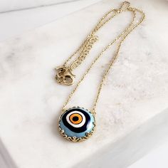 Introducing our stunning Cable Chain with a Hand-Painted 19mm Evil Eye Turkish Pendant in a Decorative Prong Setting. This gold Evil Eye Necklace is the perfect addition to any jewelry collection, with its unique design and intricate detailing. Crafted with care, this necklace features an 18+2 inch chain and a hand-painted Turkish pendant measuring 19mm in size. The evil eye symbol is said to ward off negative energy and bring good luck, making this necklace both beautiful and meaningful. Our Ca Handmade Gold Enamel Necklaces, Gold Chain Medallion Necklaces For Gifts, Gold Chain Necklace With Medallion For Gift, Gold Chain Necklace Gift, Brass Evil Eye Jewelry For Gifts, Evil Eye Brass Jewelry As A Gift, Nickel-free Gold Plated Spiritual Necklaces, Brass Evil Eye Jewelry As A Gift, Gold-tone Medallion Chain Necklace Gift