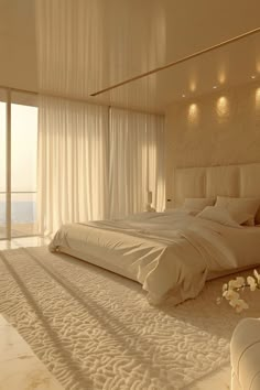 a large white bed sitting in a bedroom next to a window with curtains on it