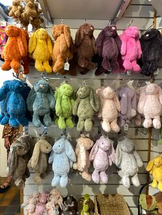 many different colored stuffed animals are on display